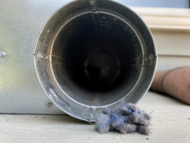 Reynoldsburg Dryer Vent Cleaning technician using specialized equipment to clear severe dryer vent blockage in Reynoldsburg